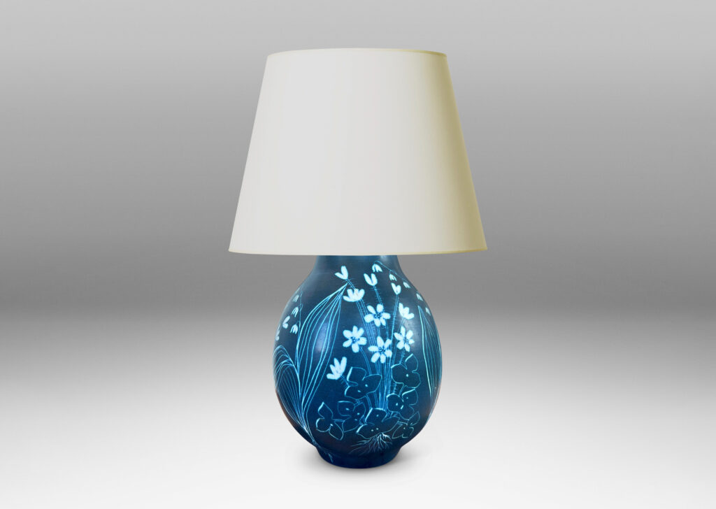 Gallery BAC ovoid form glazed in a deep cerulean tone, with a carved sgraffito wildflower design