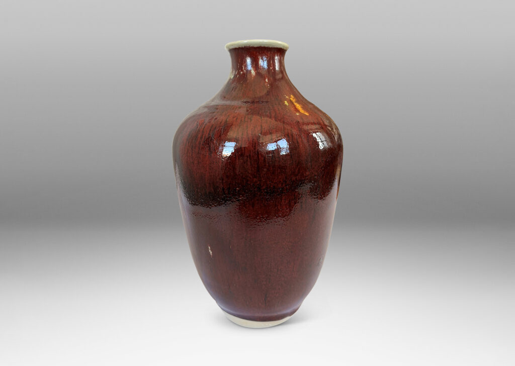 Gallery BAC tapered form glazed in a deep burgundy oxblood with pale gray accents