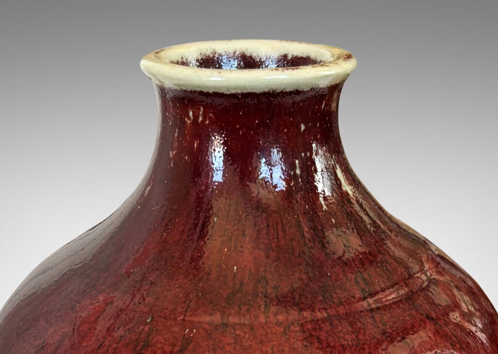 Gallery BAC tapered form glazed in a deep burgundy oxblood with pale gray accents