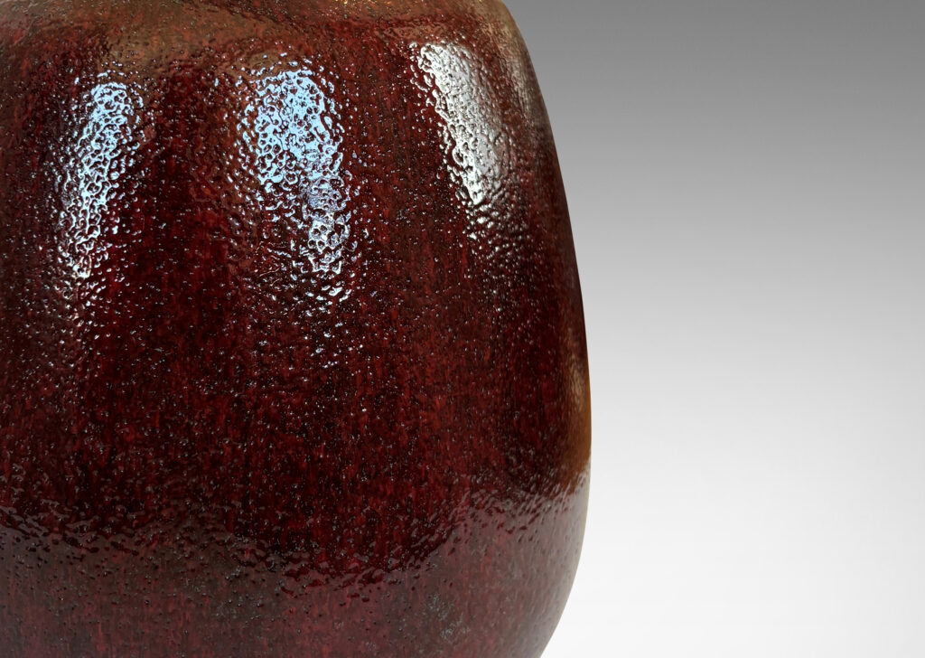 Gallery BAC ovoid form with large articulated mouth, glazed in a deep burgundy oxblood with pale gray accents