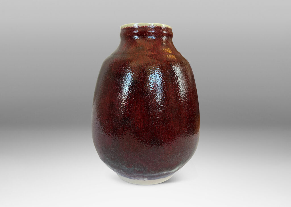 Gallery BAC ovoid form with large articulated mouth, glazed in a deep burgundy oxblood with pale gray accents
