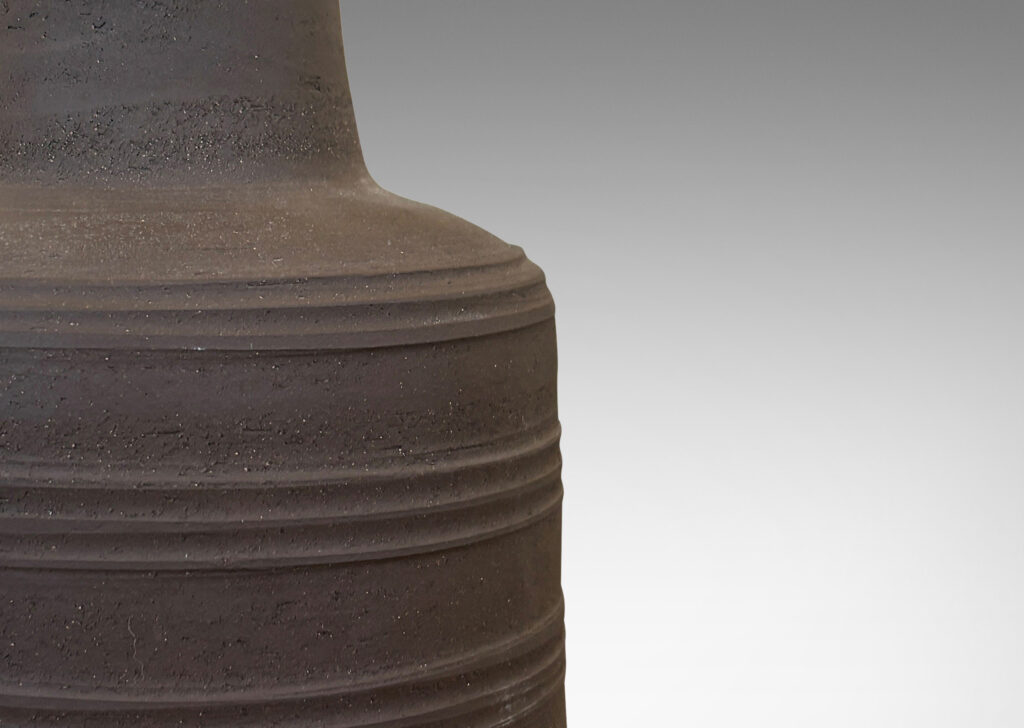 Gallery BAC drum forms with decorative ridge bands and tall conical necks in matte brown