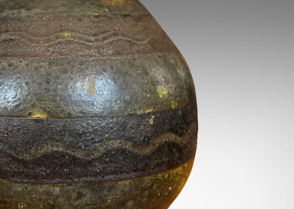 Gallery BAC spherical form ornamented with black horizontal bands decorated with sgraffito waves, overglazed in a flowing moody green
