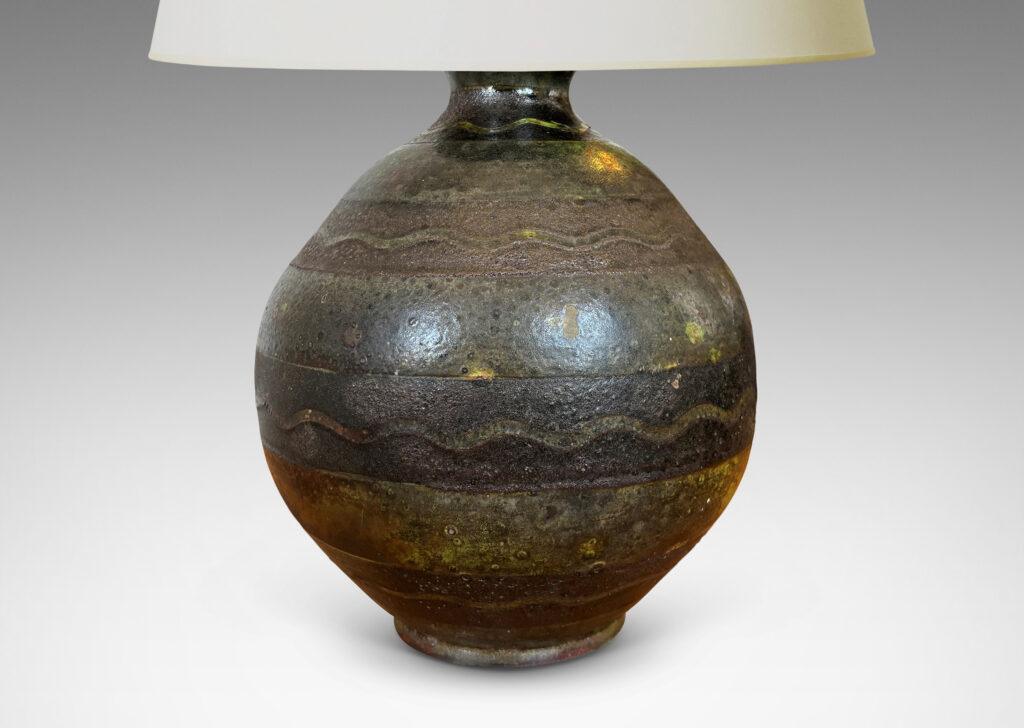 Gallery BAC spherical form ornamented with black horizontal bands decorated with sgraffito waves, overglazed in a flowing moody green