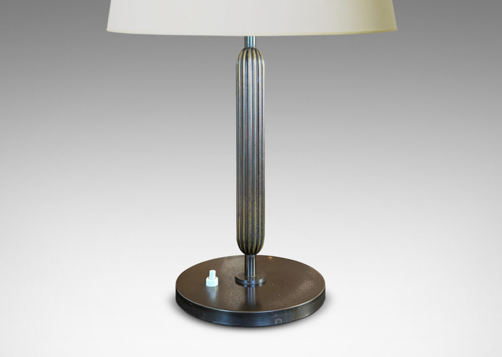 Gallery BAC reeded floating stand, with reveals above and below, and disk base, patinated in an antique bronze