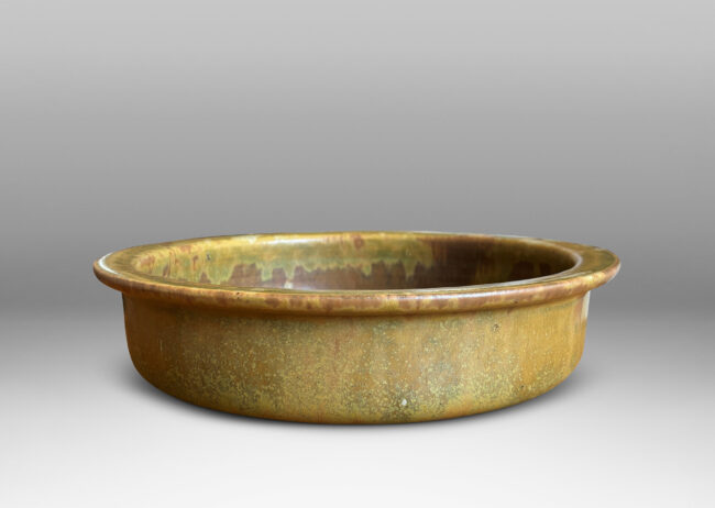 Gallery BAC flat bottom and upright sides with flange lip, glazed in a marvelous mottled warm brown with flowing mustard tone highlights around rim