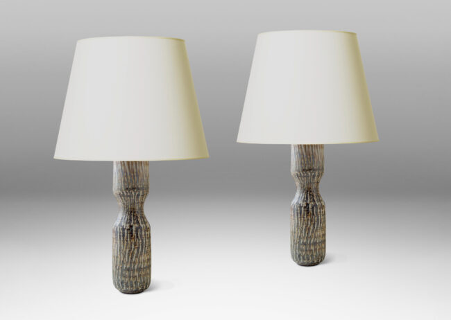 Gallery BAC slender hourglass form with a waist-like cinch and carved texture of diagonal hatches in stoneware with a flowing brown “Birka” glaze