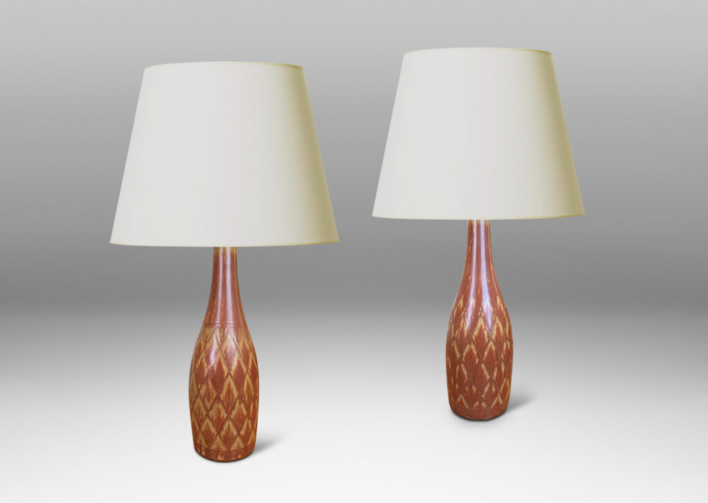 Gallery BAC tall bottle forms with carved diamond pattern, and glazed in terra-cotta/tan