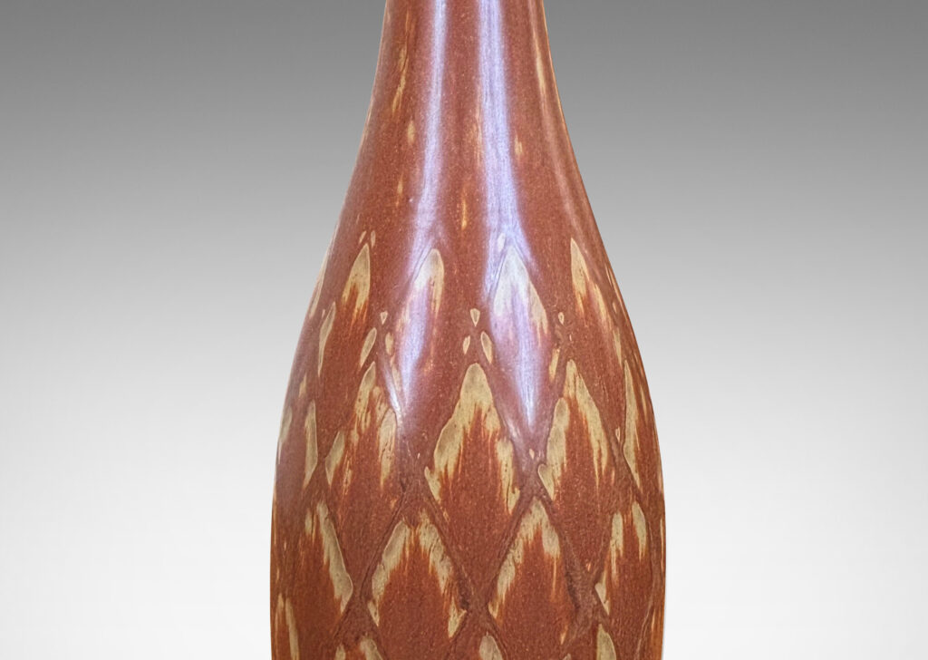 Gallery BAC tall bottle forms with carved diamond pattern, and glazed in terra-cotta/tan