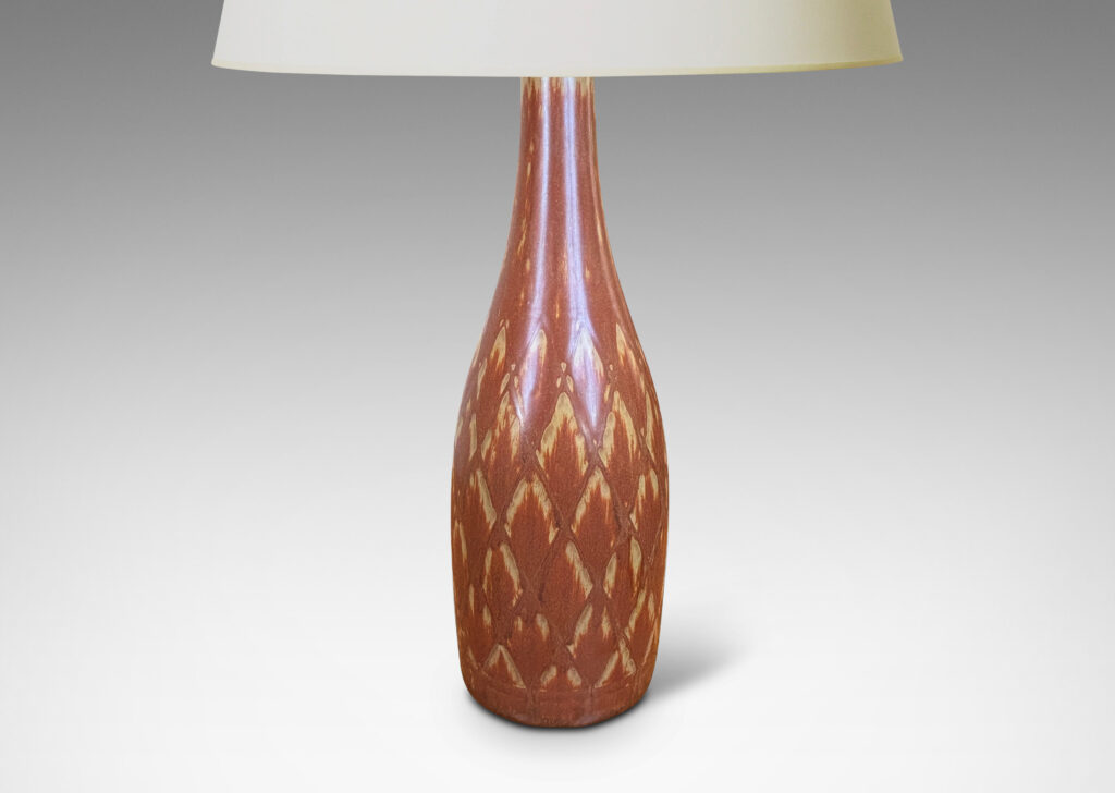 Gallery BAC tall bottle forms with carved diamond pattern, and glazed in terra-cotta/tan