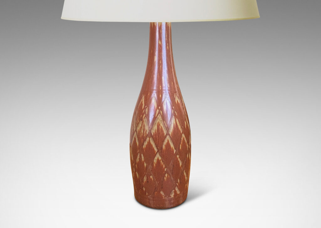 Gallery BAC tall bottle forms with carved diamond pattern, and glazed in terra-cotta/tan
