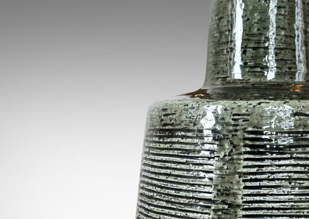 Gallery BAC drum form with carved line panels and tall conical neck, glazed in a gray-green
