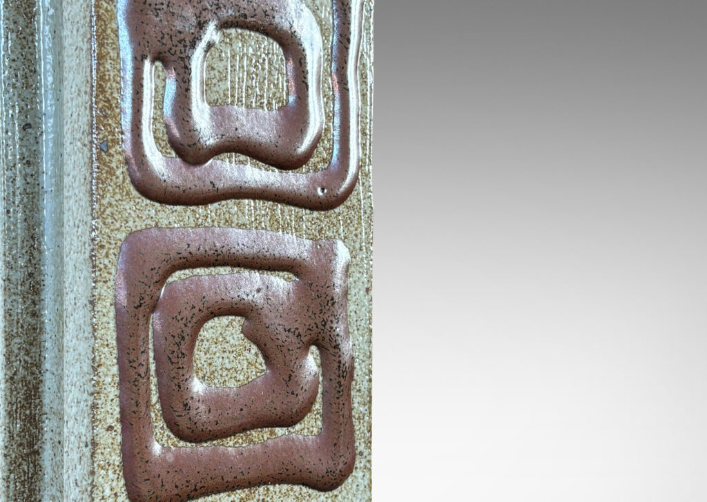 Gallery BAC two floating rectangular planes connected by a central pillar, glazed in dappled gray-brown with concentric square motifs in red luster