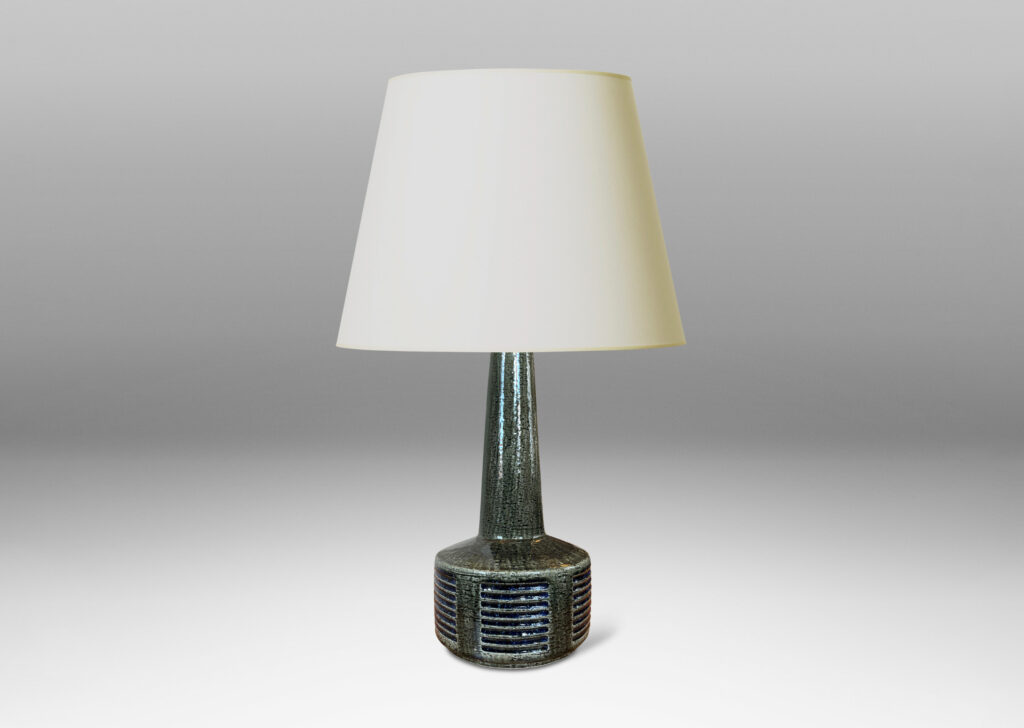 Gallery BAC low drum form with carved score patterning and tall neck, glazed in a shiny gray-green, with blue accents