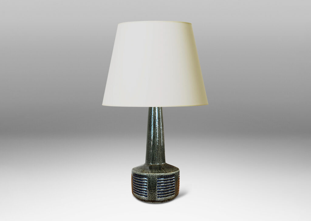 Gallery BAC low drum form with carved score patterning and tall neck, glazed in a shiny gray-green, with blue accents