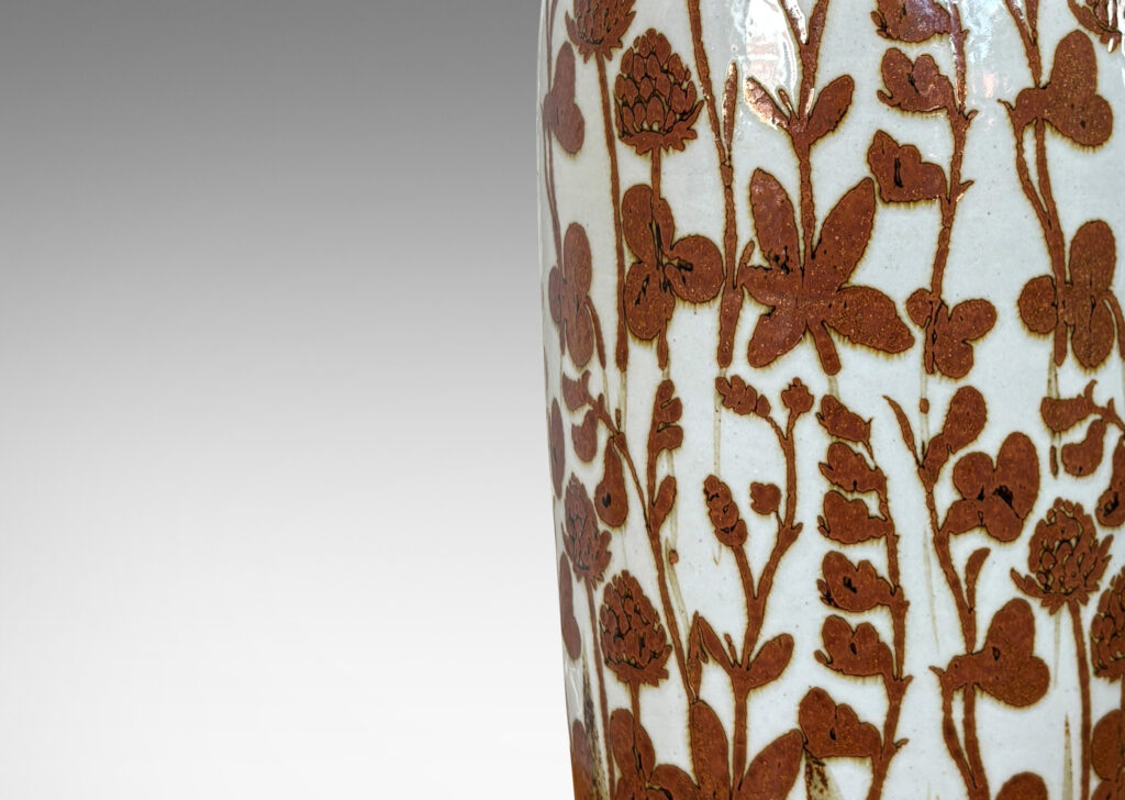 Gallery BAC all tapered form glazed in pale pearl gray overpainted with a wildflower pattern in rust red luster