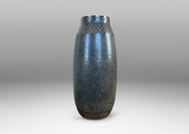Gallery BAC tall swelling form with carved diamond pattern at top, glazed in dark gray and black