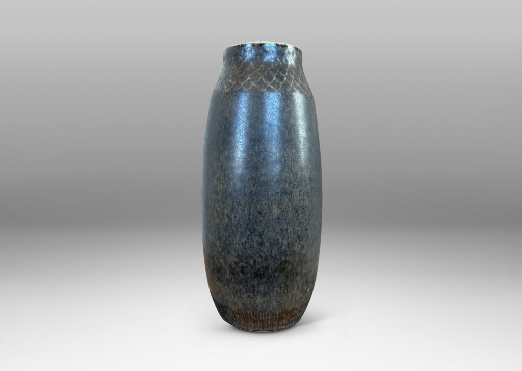 Gallery BAC tall swelling form with carved diamond pattern at top, glazed in dark gray and black