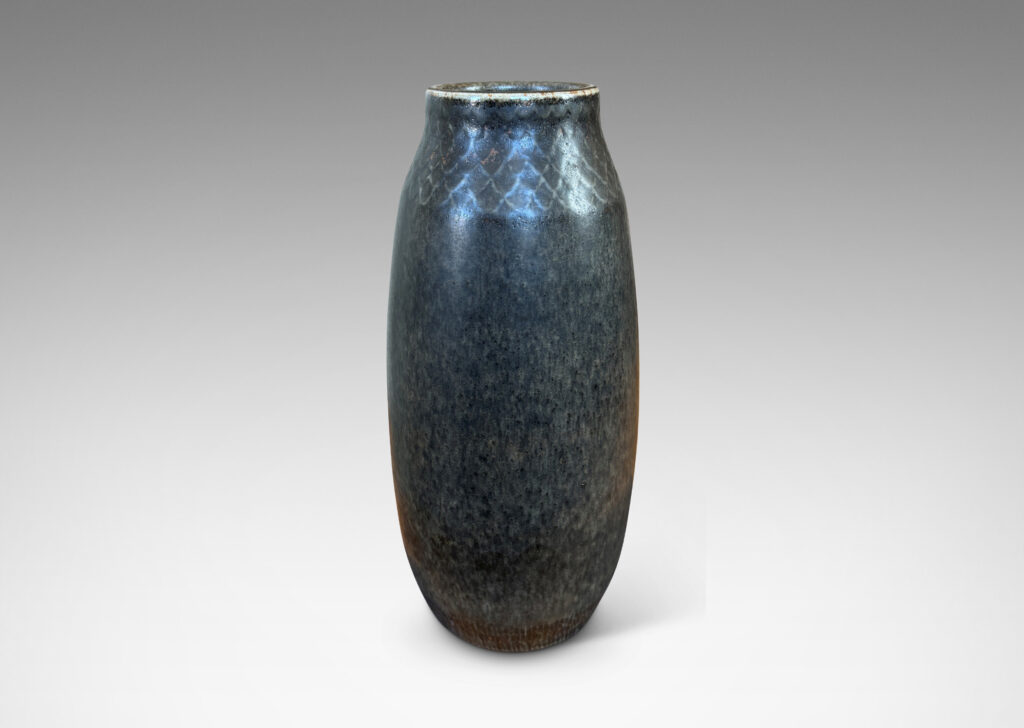 Gallery BAC tall swelling form with carved diamond pattern at top, glazed in dark gray and black