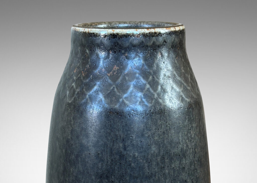 Gallery BAC tall swelling form with carved diamond pattern at top, glazed in dark gray and black