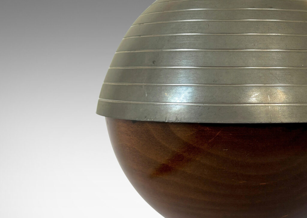 Gallery BAC globe form, with ringed top hemisphere and flanged base in pewter with wood lower hemisphere