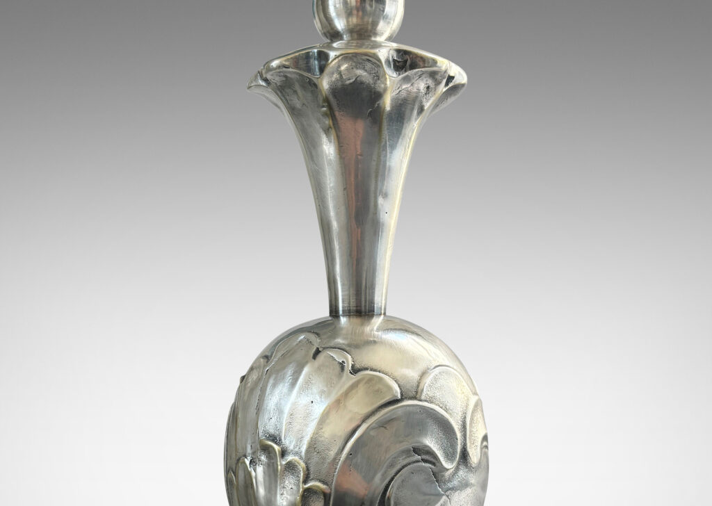 Gallery BAC ovoid form with bold acanthus leaf pattern reliefs, with trumpeting foot and neck, mounted on a stepped disk plinth