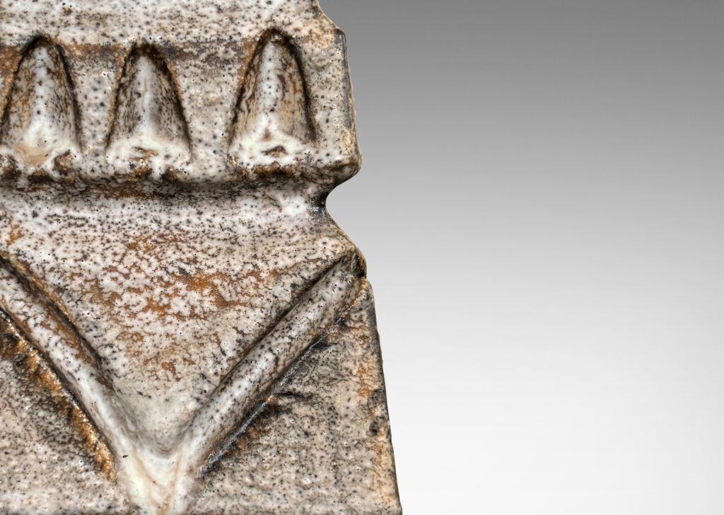 Gallery BAC square tapered obelisk-like forms with carved patterns of triangle motifs, glazed in running pale gray and matte brown