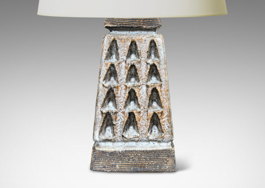 Gallery BAC square tapered obelisk-like forms with carved patterns of triangle motifs, glazed in running pale gray and matte brown