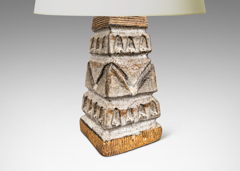 Gallery BAC square tapered obelisk-like forms with carved patterns of triangle motifs, glazed in running pale gray and matte brown