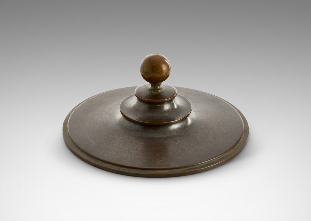 Gallery BAC sinuously modeled “U” form on a stepped disk plinth, with tiered lid topped with a sphere finial; patinate bronze