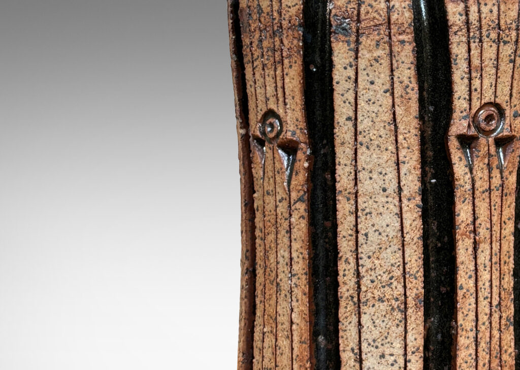 Gallery BAC unglazed cylindrical form with deeply carved ribs, with chocolate brown glazed top and stripes