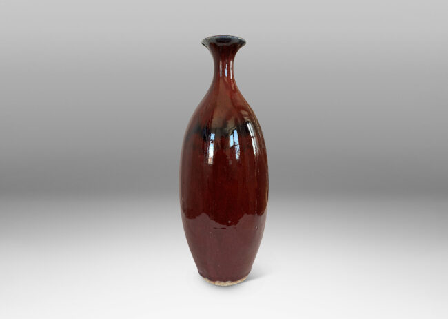 Gallery BAC tall sinuously modeled form in a gloss burgundy oxblood glaze