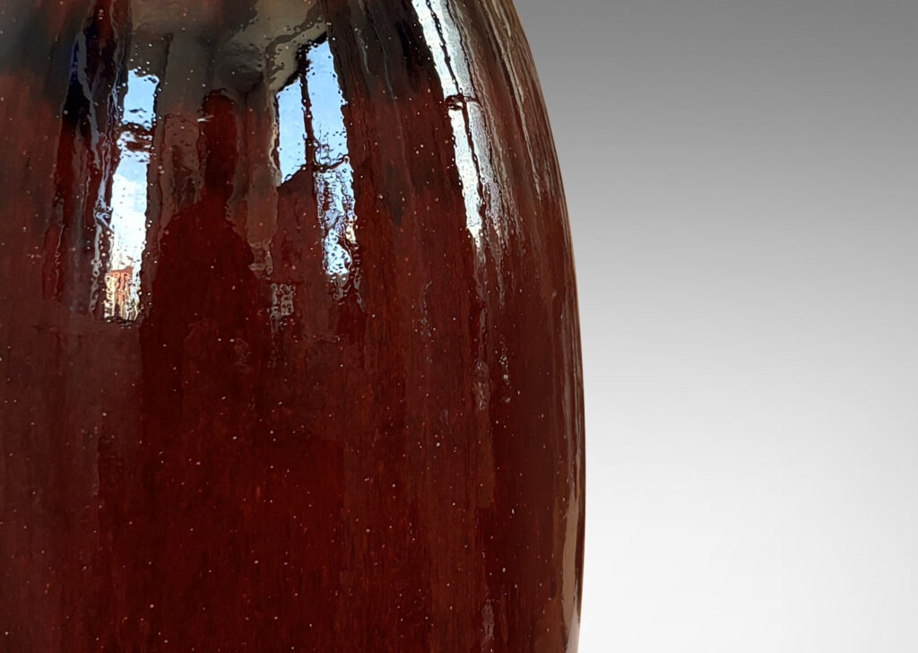 Gallery BAC tall sinuously modeled form in a gloss burgundy oxblood glaze
