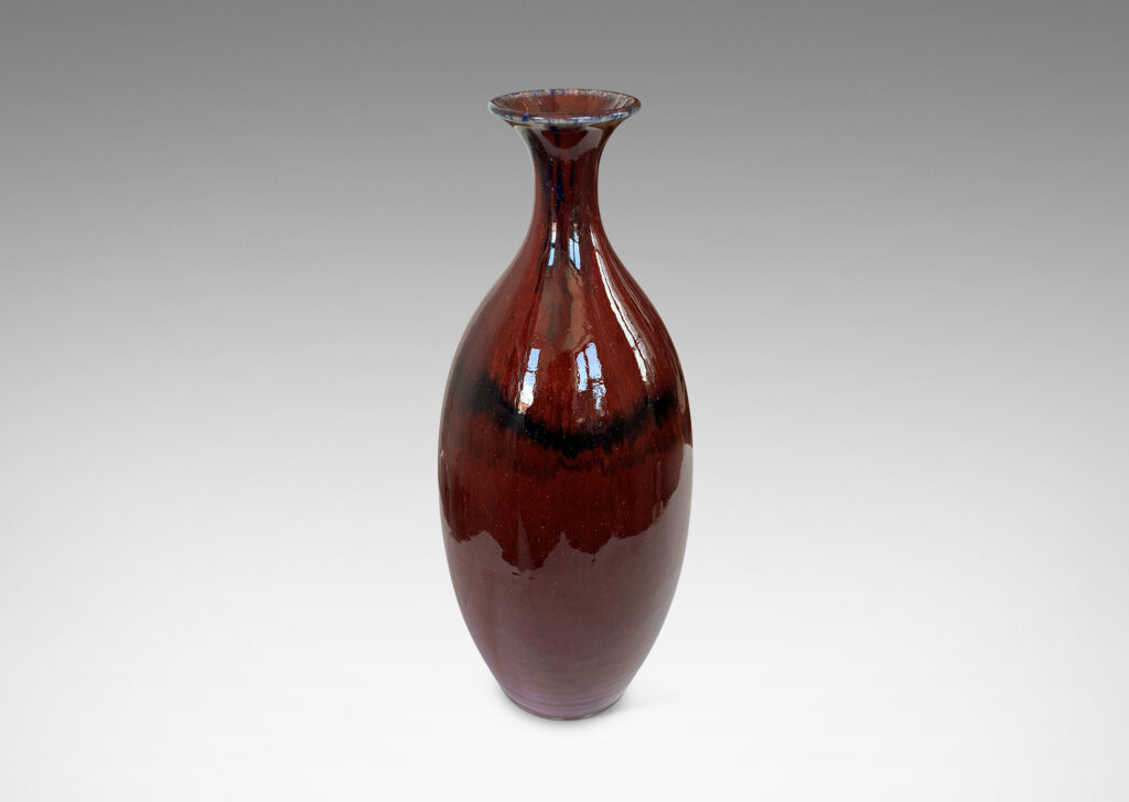Gallery BAC tall sinuously modeled form in a gloss burgundy oxblood glaze