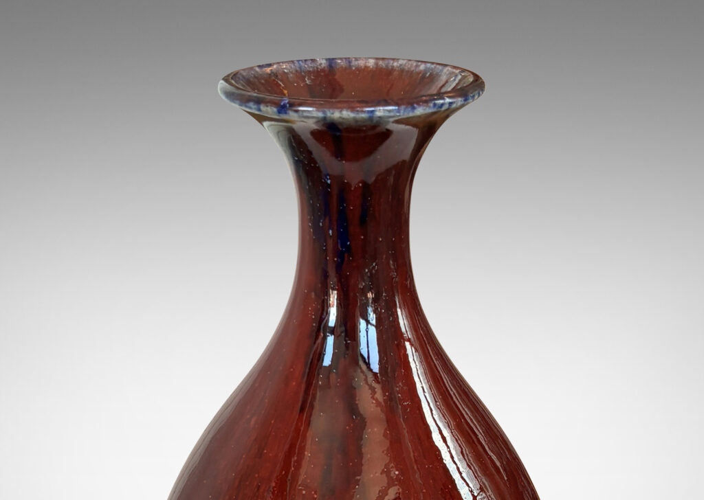 Gallery BAC tall sinuously modeled form in a gloss burgundy oxblood glaze