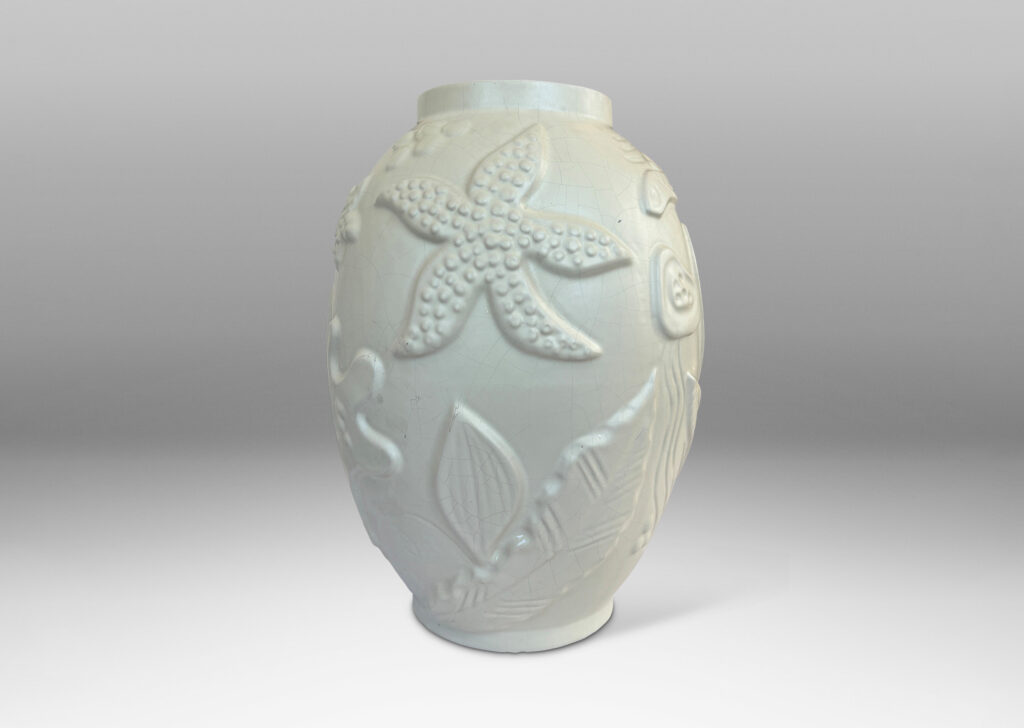 Gallery BAC void form with reliefs depicting marine flora and fauna in an eggshell finish warm ivory glaze