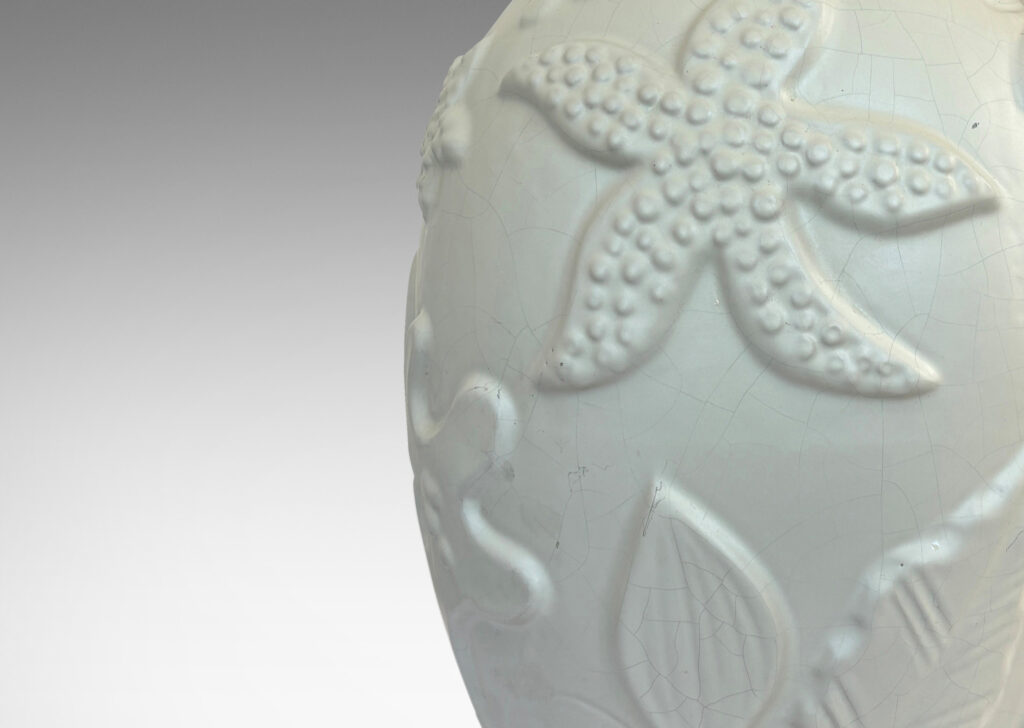 Gallery BAC void form with reliefs depicting marine flora and fauna in an eggshell finish warm ivory glaze