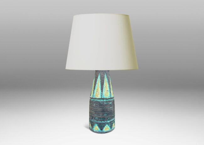 Gallery BAC cylindrical form with its top half upwardly tapered, with carved triangular motifs, glazed in matte brown with green and mustard yellow