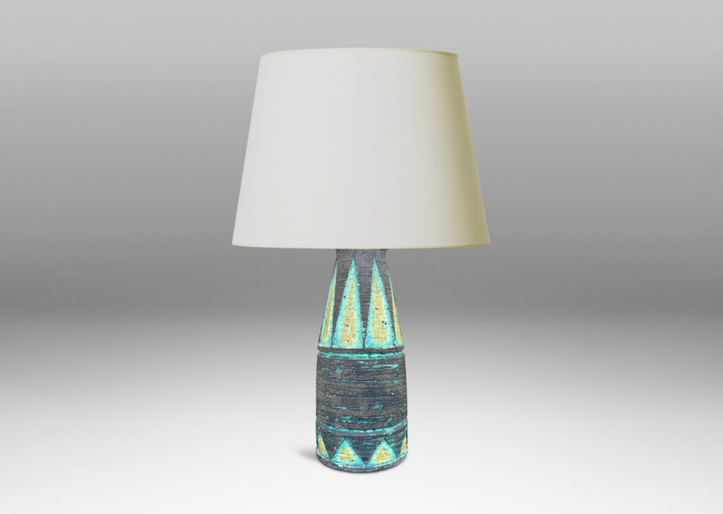 Gallery BAC cylindrical form with its top half upwardly tapered, with carved triangular motifs, glazed in matte brown with green and mustard yellow