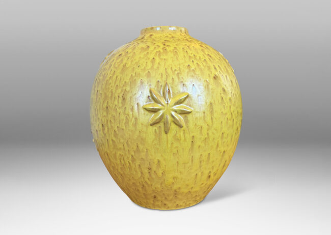 Gallery BAC large tapered globe form with floating star motifs, in a flowing yellow glaze with brown accents