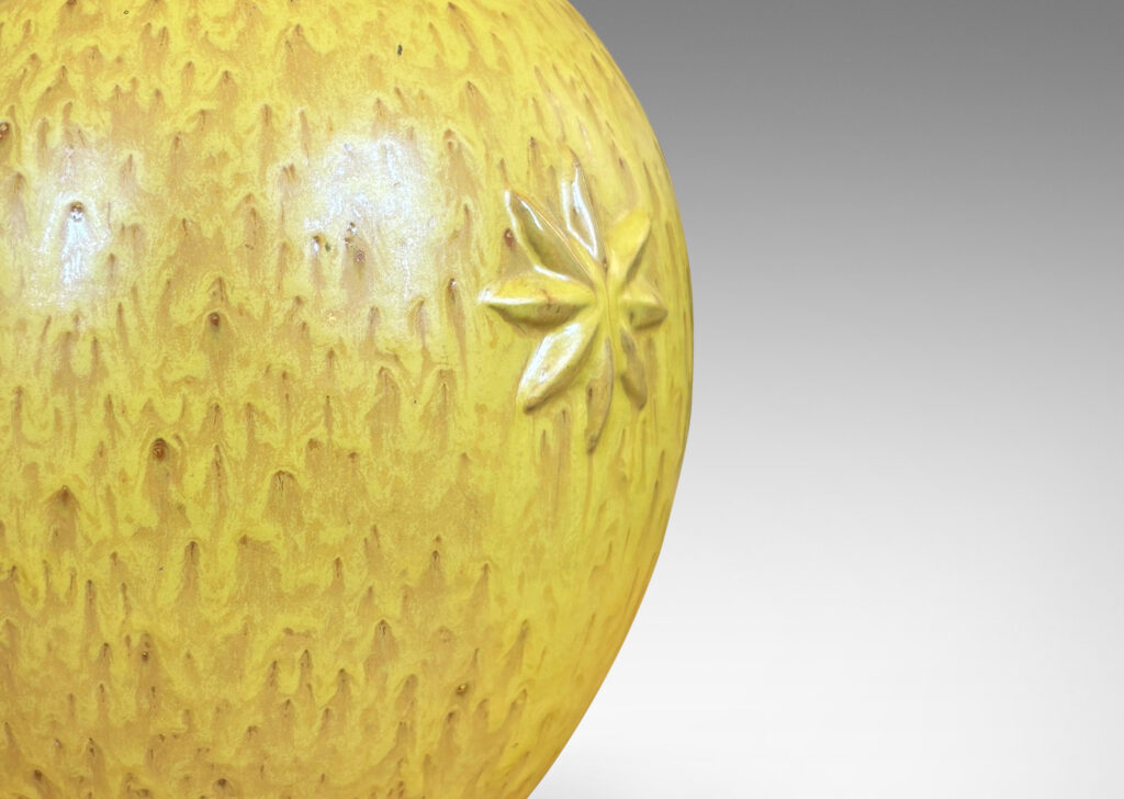 Gallery BAC large tapered globe form with floating star motifs, in a flowing yellow glaze with brown accents