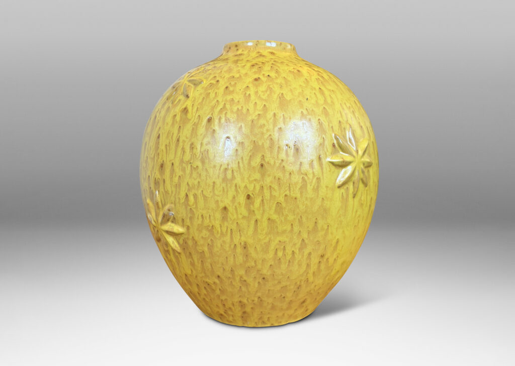 Gallery BAC large tapered globe form with floating star motifs, in a flowing yellow glaze with brown accents