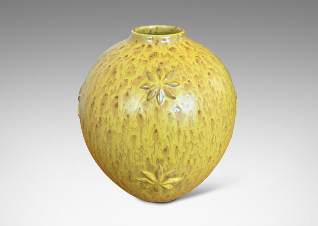 Gallery BAC large tapered globe form with floating star motifs, in a flowing yellow glaze with brown accents