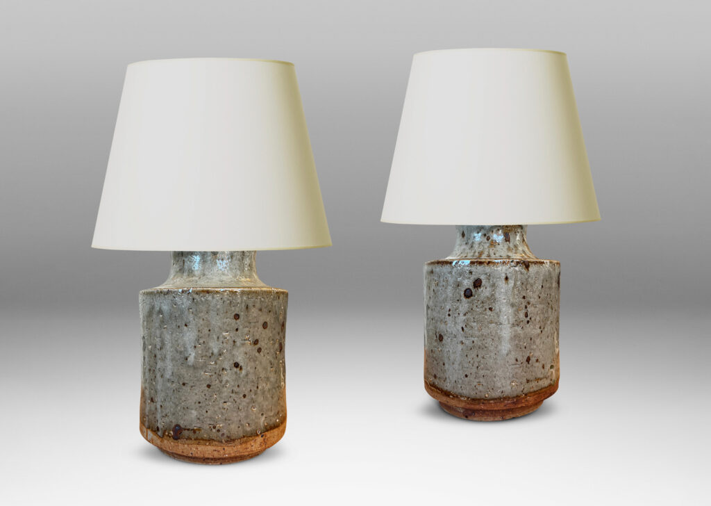 Gallery BAC cylindrical bodies with coved necks, glazed in a greenish pale gray with dark dappling
