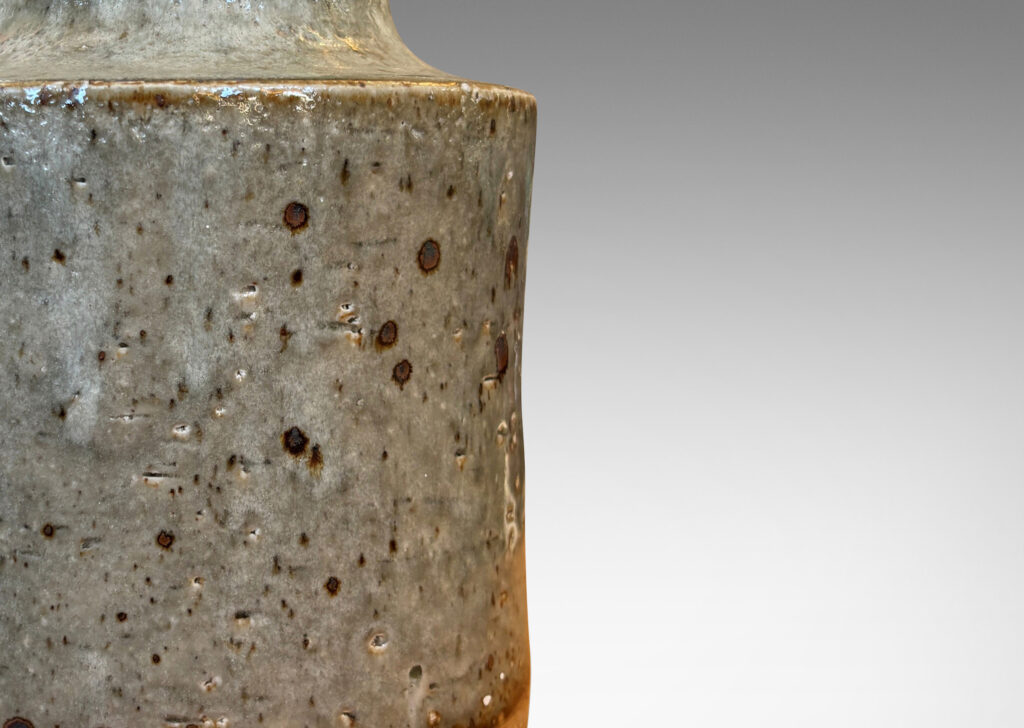 Gallery BAC cylindrical bodies with coved necks, glazed in a greenish pale gray with dark dappling