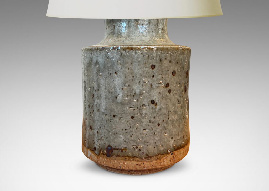 Gallery BAC cylindrical bodies with coved necks, glazed in a greenish pale gray with dark dappling