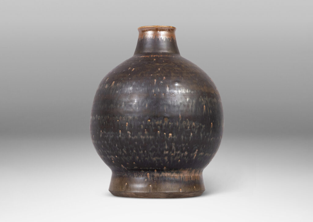 Gallery BAC globe form with flared base and tapered neck, glazed in black and red luster