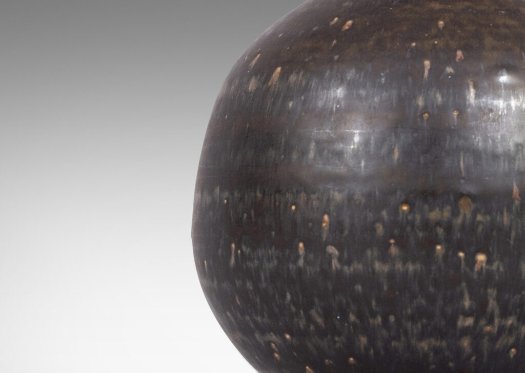 Gallery BAC globe form with flared base and tapered neck, glazed in black and red luster