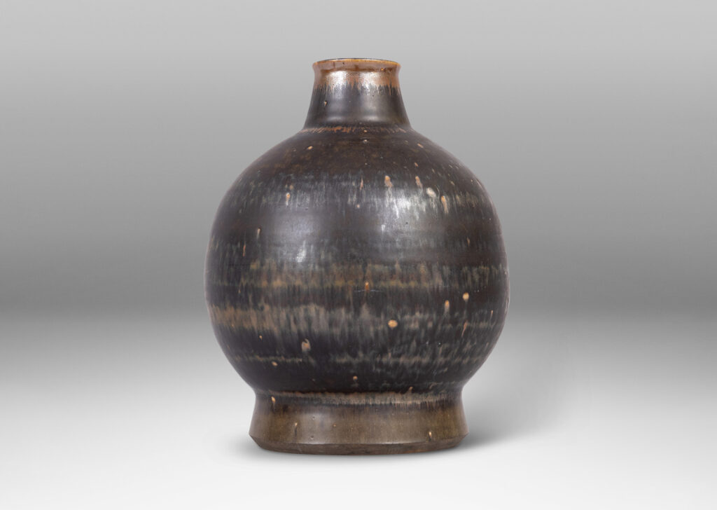 Gallery BAC globe form with flared base and tapered neck, glazed in black and red luster