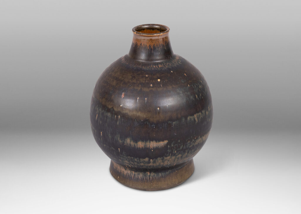 Gallery BAC globe form with flared base and tapered neck, glazed in black and red luster